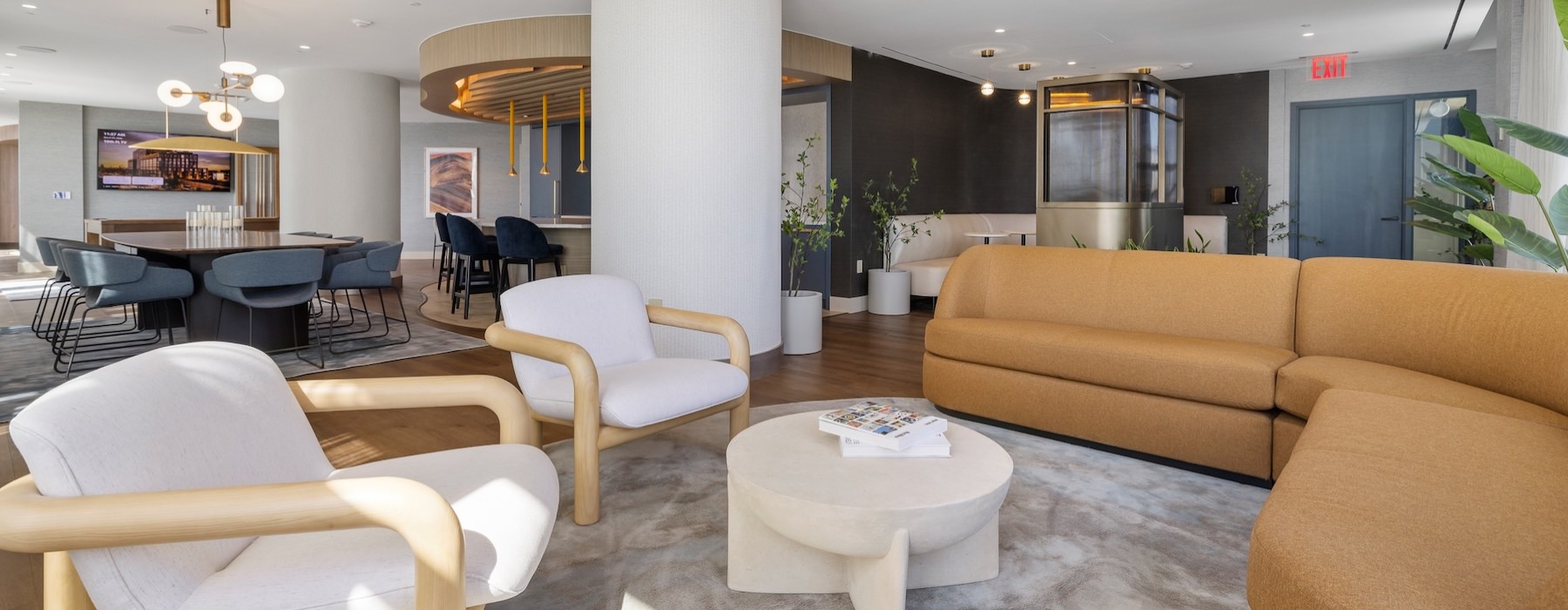 a lounge area with a couch and chairs